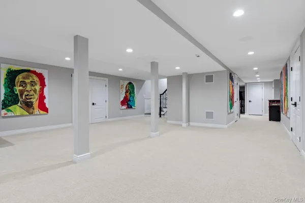 a spacious bedroom with a bed and a view of kitchen