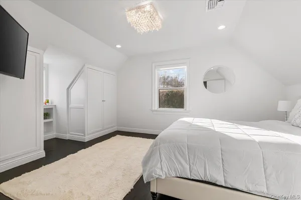 a bathroom with a granite countertop bathtub shower sink vanity and toilet