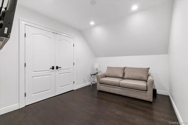 a living room with furniture and a book shelf
