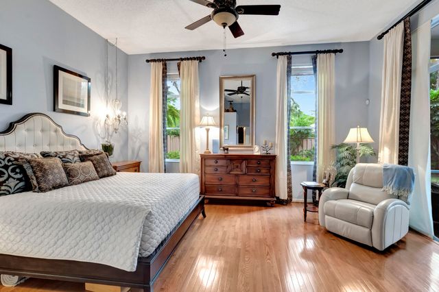 a bathroom with a granite countertop double vanity sink and a mirror