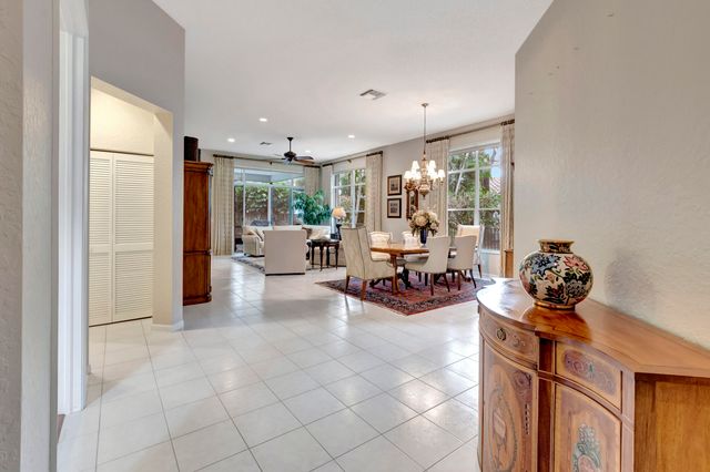 a living room with furniture a dining table and a large window