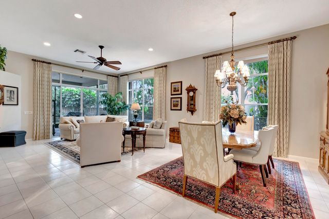 a living room with furniture a dining table and a large window