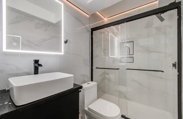 a bathroom with a sink toilet and shower