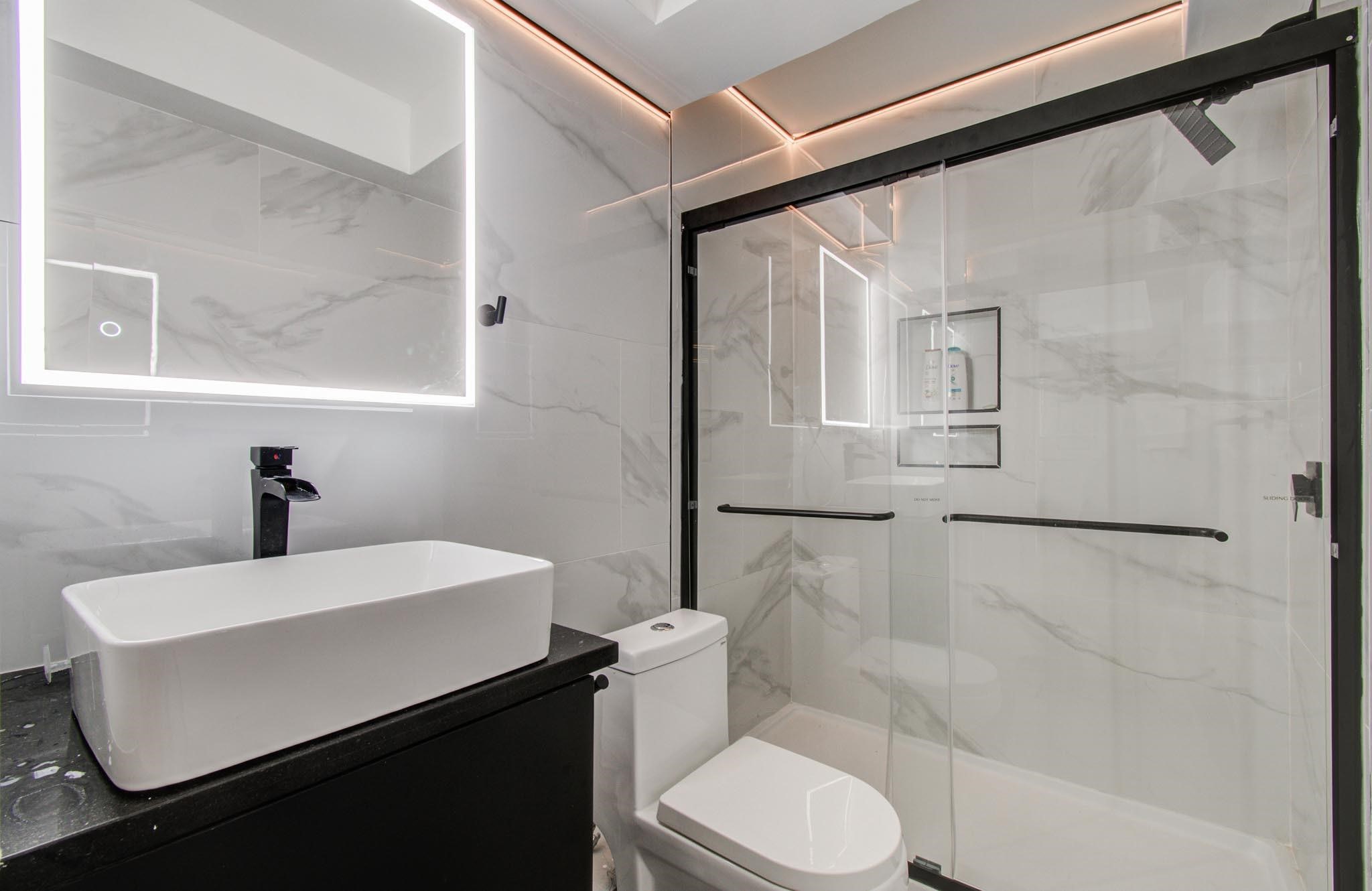 4641 Wild Indigo Street, Unit 433 Houston, TX 77027 - Photo 11 of 21 a bathroom with a sink toilet and shower