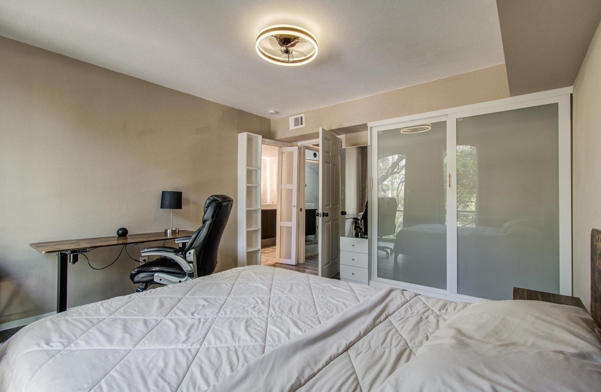 4641 Wild Indigo Street, Unit 433 Houston, TX 77027 - Photo 12 of 21 a bedroom with a bed and a desk