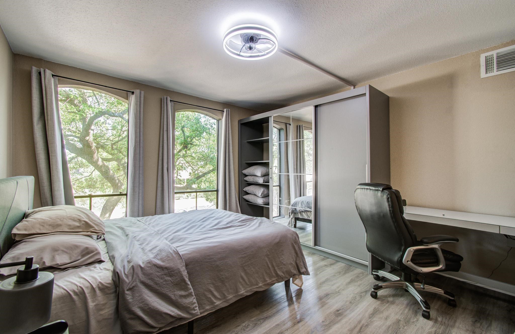 4641 Wild Indigo Street, Unit 433 Houston, TX 77027 - Photo 14 of 21 a bedroom with a bed and a chair