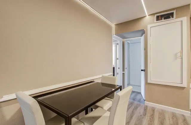 a view of a room with wooden floor