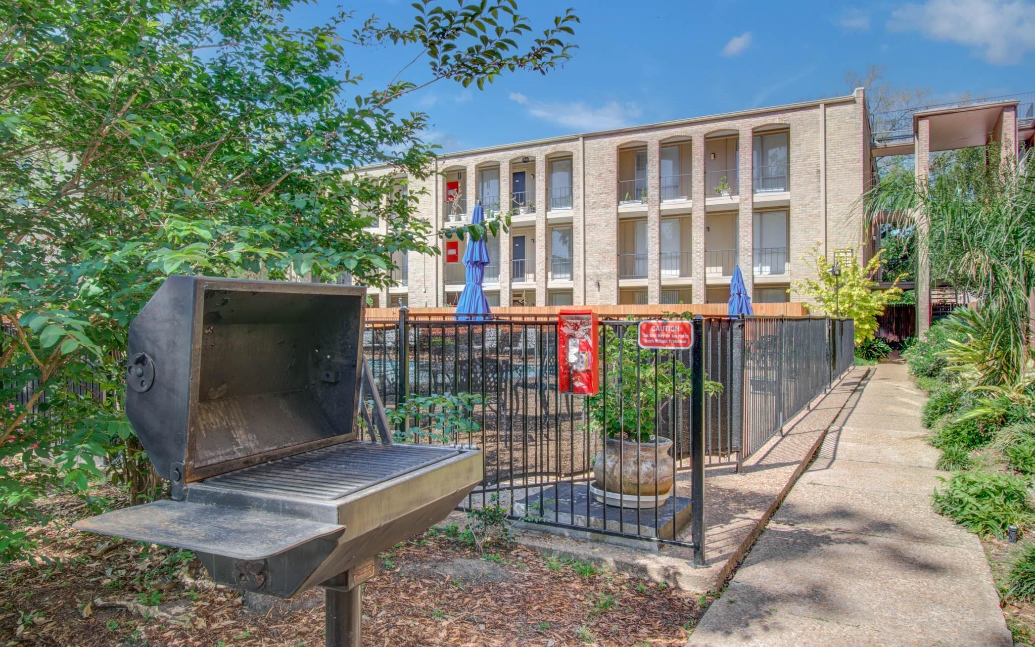 4641 Wild Indigo Street, Unit 433 Houston, TX 77027 - Photo 18 of 21 a view of a house with a yard and potted plants