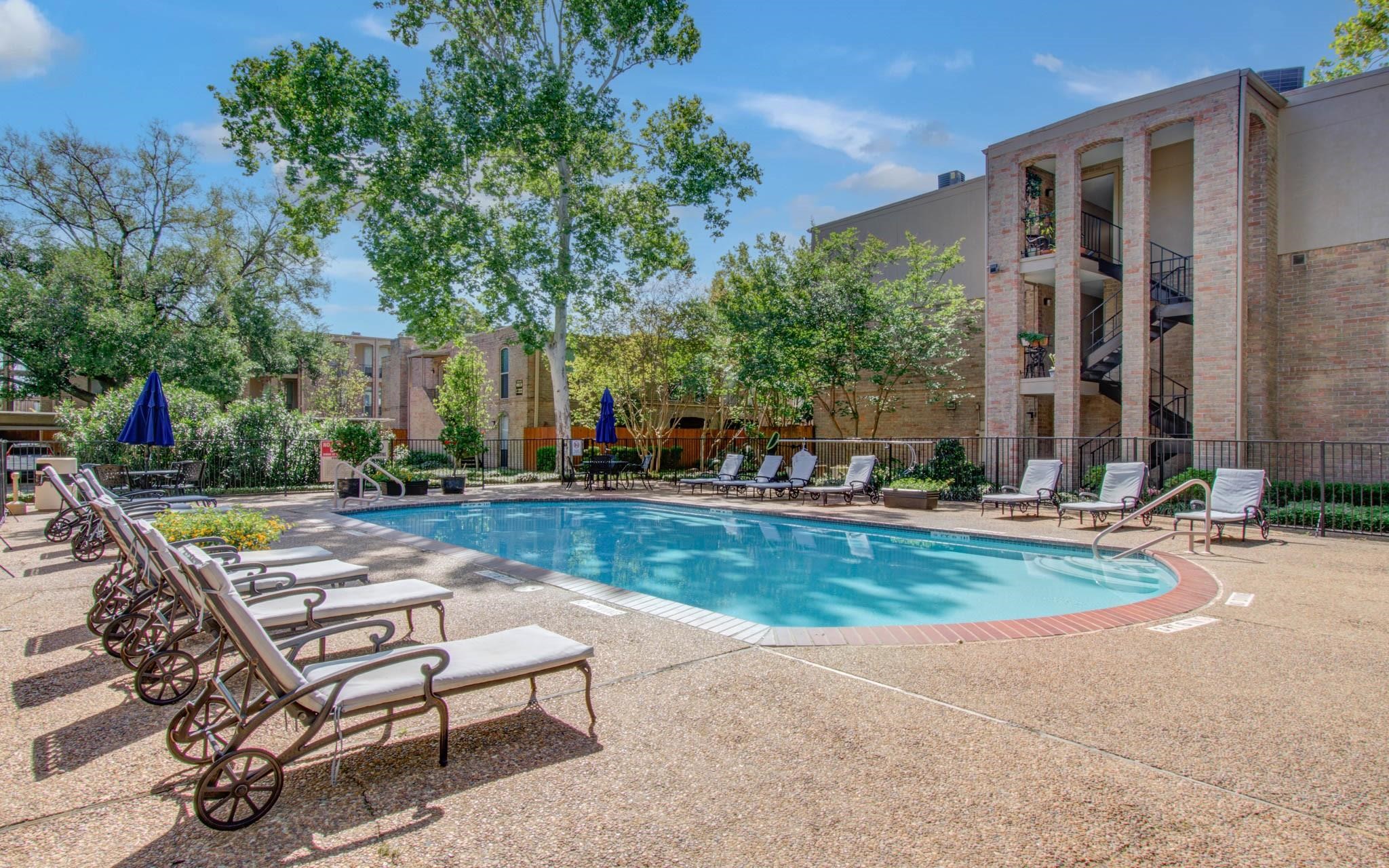 4641 Wild Indigo Street, Unit 433 Houston, TX 77027 - Photo 20 of 21 a backyard of a house with barbeque oven table and chairs