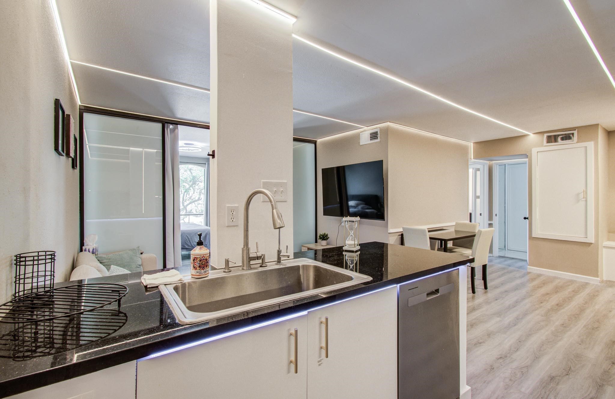 4641 Wild Indigo Street, Unit 433 Houston, TX 77027 - Photo 3 of 21 a kitchen with a sink and a refrigerator