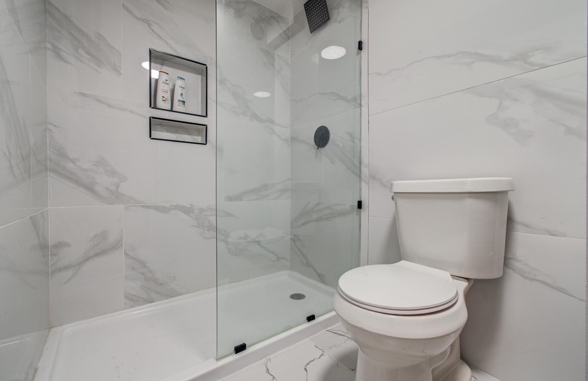 4641 Wild Indigo Street, Unit 433 Houston, TX 77027 - Photo 9 of 21 a bathroom with a toilet and shower