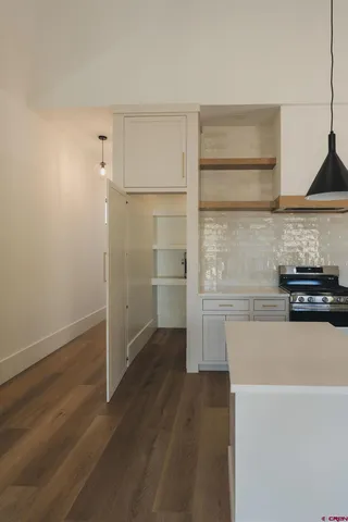 a kitchen with a refrigerator and a stove top oven