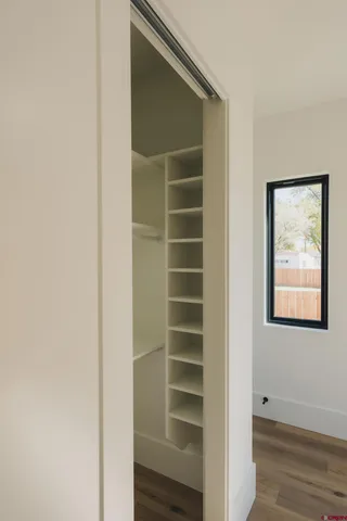 a view of walk in closet with empty racks