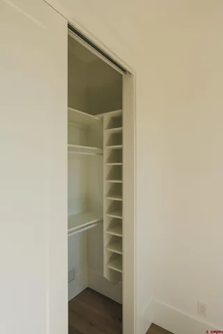 a view of walk in closet with empty racks