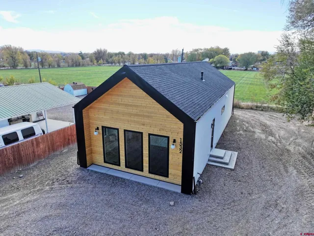 a aerial view of a house next to a yard