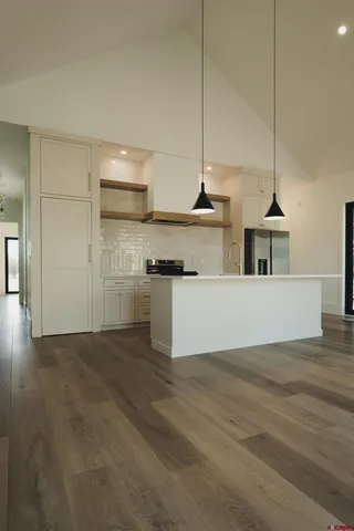 a kitchen with stainless steel appliances kitchen island a cabinets and wooden floor