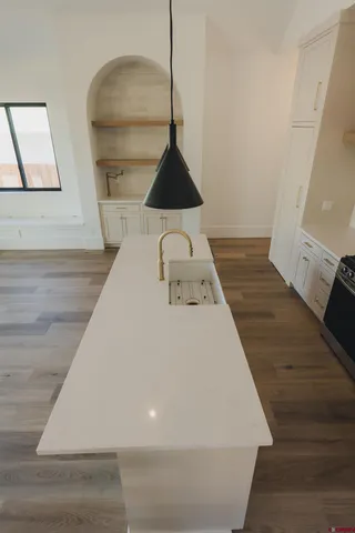 a close view of wooden floor and utility room