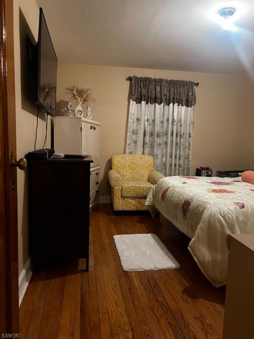 1259 Grandview Avenue Union, NJ 07083 - Photo 4 of 5 a bedroom with a bed and a flat tv screen on dresser
