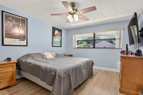 a spacious bathroom with a granite countertop sink a mirror and a shower
