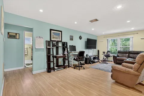 a view of a livingroom with workspace and a window