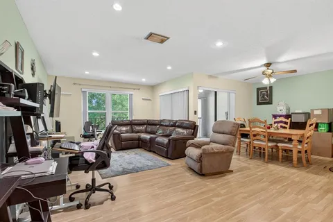 a living room with lots of furniture and a wooden floor