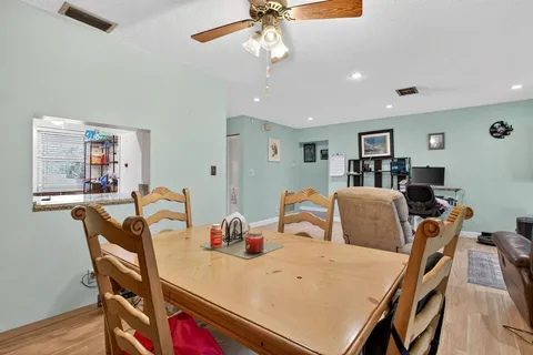 a view of a dining room with furniture and wooden floor