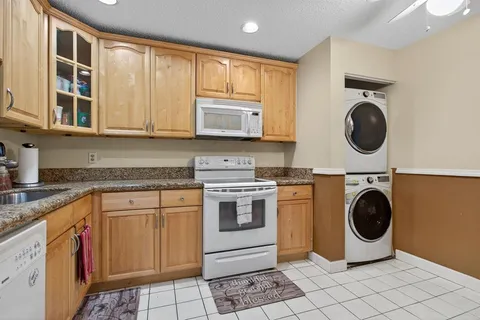 a kitchen with a stove a sink and a microwave