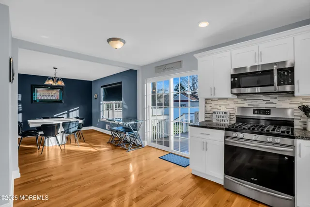 a kitchen with stainless steel appliances a stove a sink and a microwave
