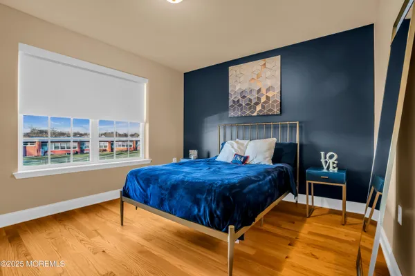 a bedroom with a large bed and a window