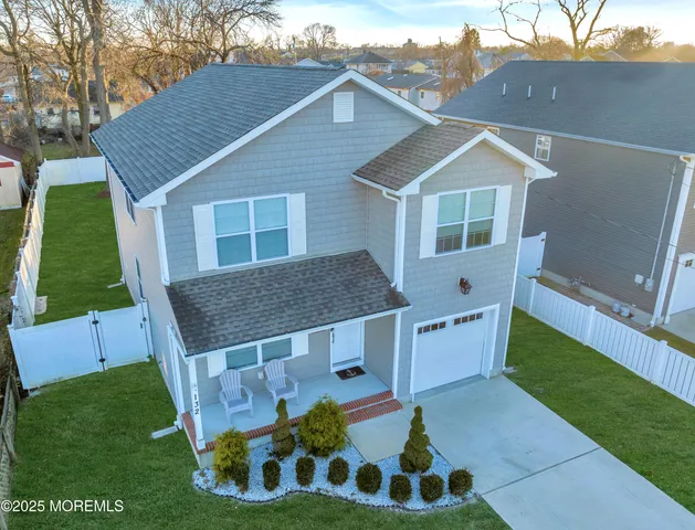 a aerial view of a house with a yard