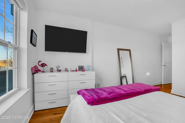 a bedroom with a bed and flat screen tv