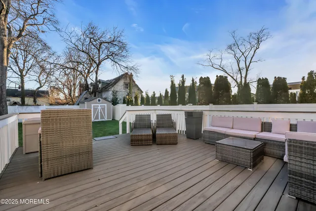 a view of a deck with couches and wooden floor