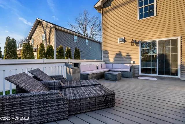 a view of a roof deck with couches and wooden floor
