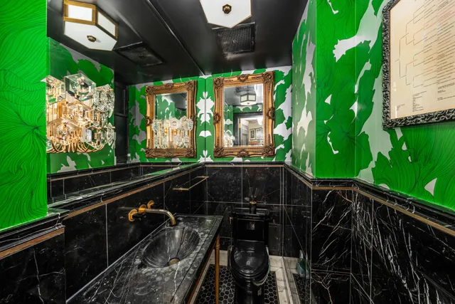 a view of a balcony with chairs and a potted plant
