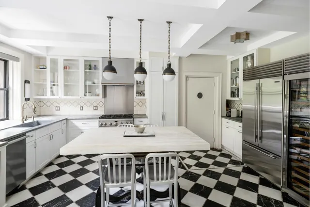 a kitchen with a sink a refrigerator and cabinets