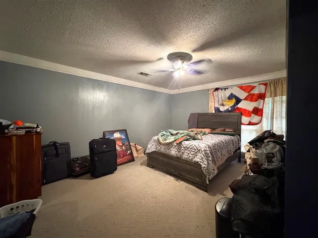 a bedroom with bed and a chandelier