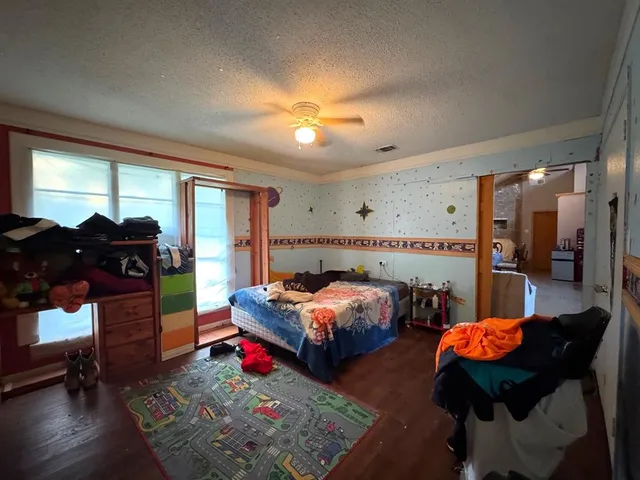 a bedroom with bed and window