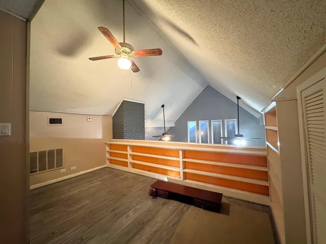 a view of room with stairs and a ceiling fan