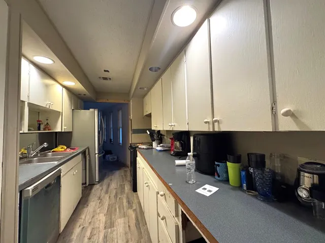 a kitchen with stainless steel appliances sink stove and cabinets