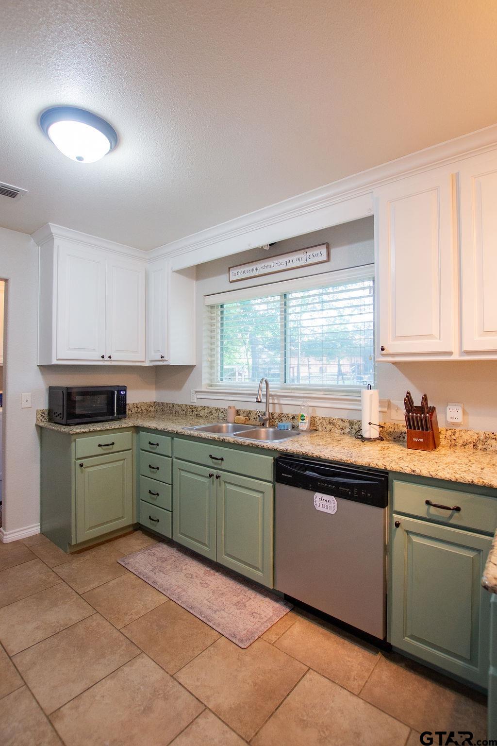 2110 Inwood Circle Tyler, TX 75701 - Photo 12 of 44 a kitchen with granite countertop cabinets sink and stainless steel appliances