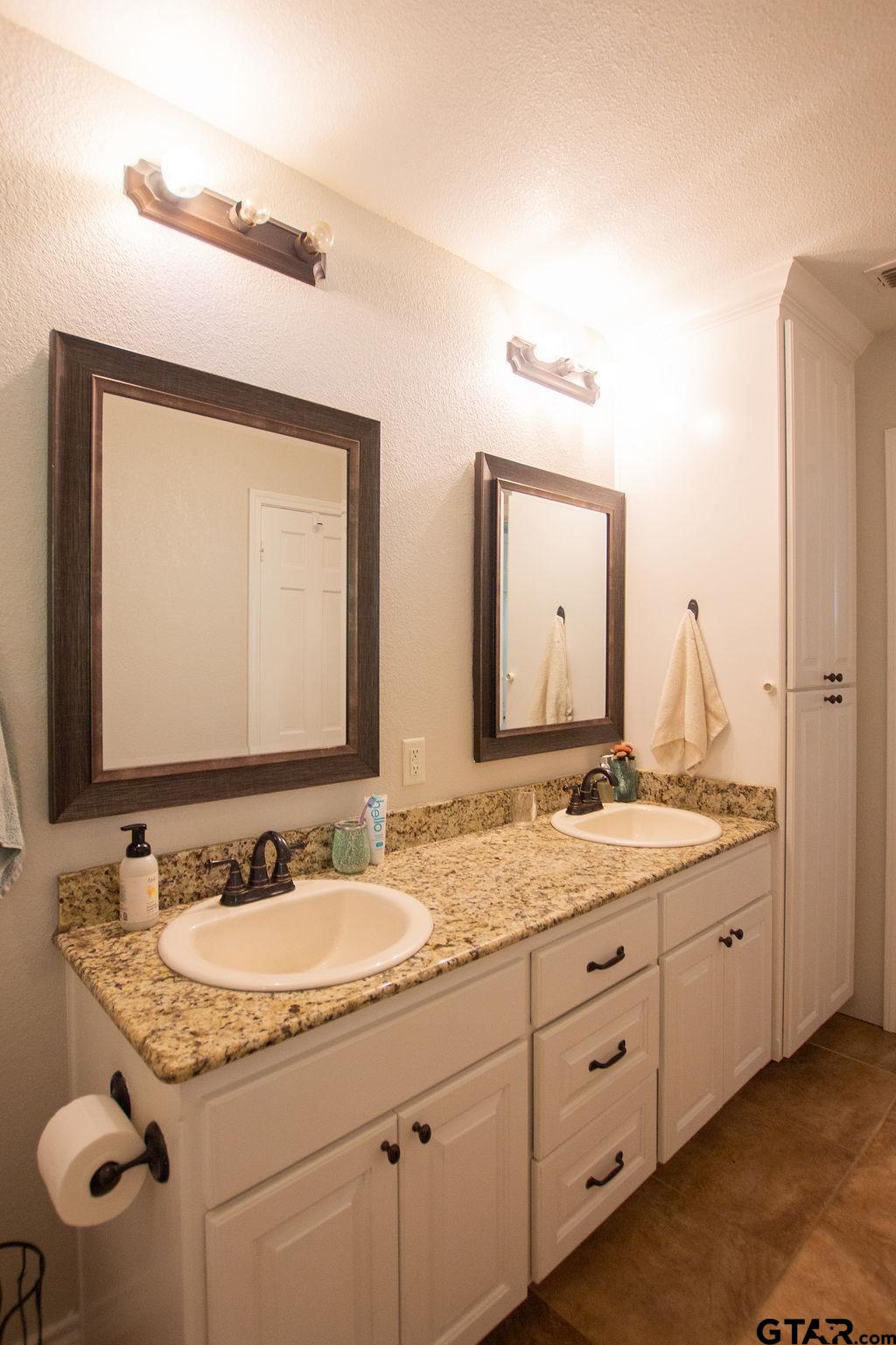 2110 Inwood Circle Tyler, TX 75701 - Photo 18 of 44 a bathroom with a granite countertop sink double and mirror