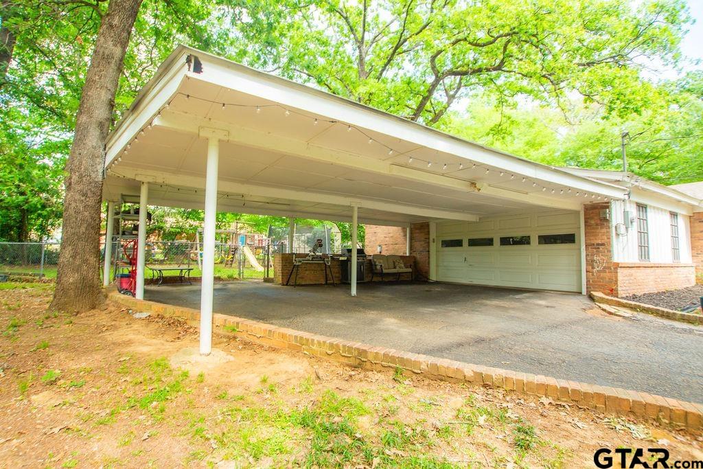 2110 Inwood Circle Tyler, TX 75701 - Photo 2 of 44 a backyard of a house with table and chairs