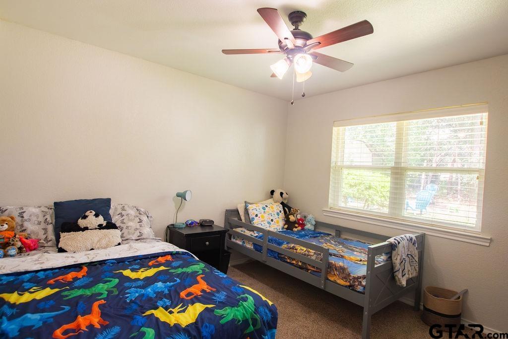 2110 Inwood Circle Tyler, TX 75701 - Photo 21 of 44 a bedroom with a bed and wooden floor