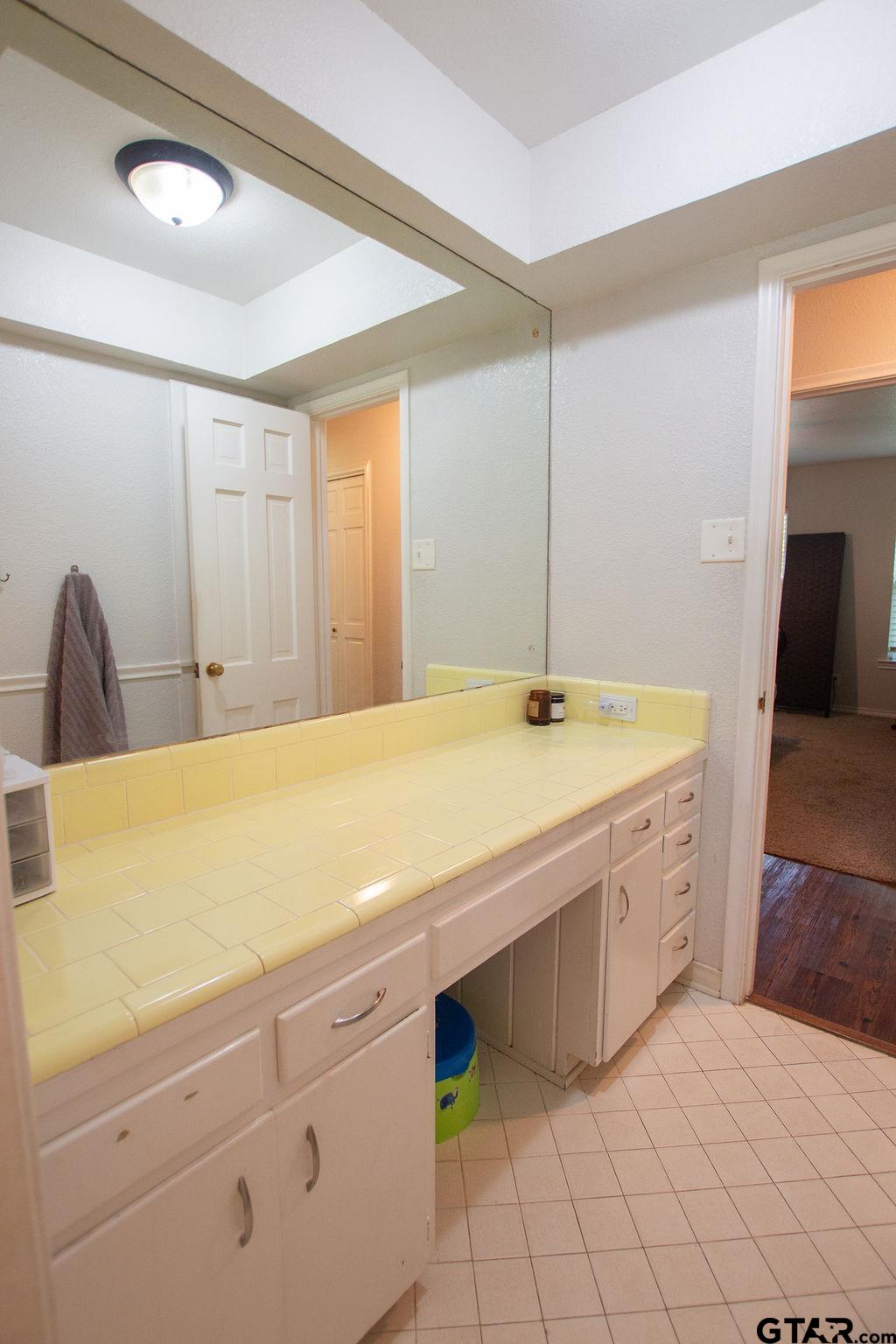 2110 Inwood Circle Tyler, TX 75701 - Photo 23 of 44 a spacious bathroom with a granite countertop sink and a mirror