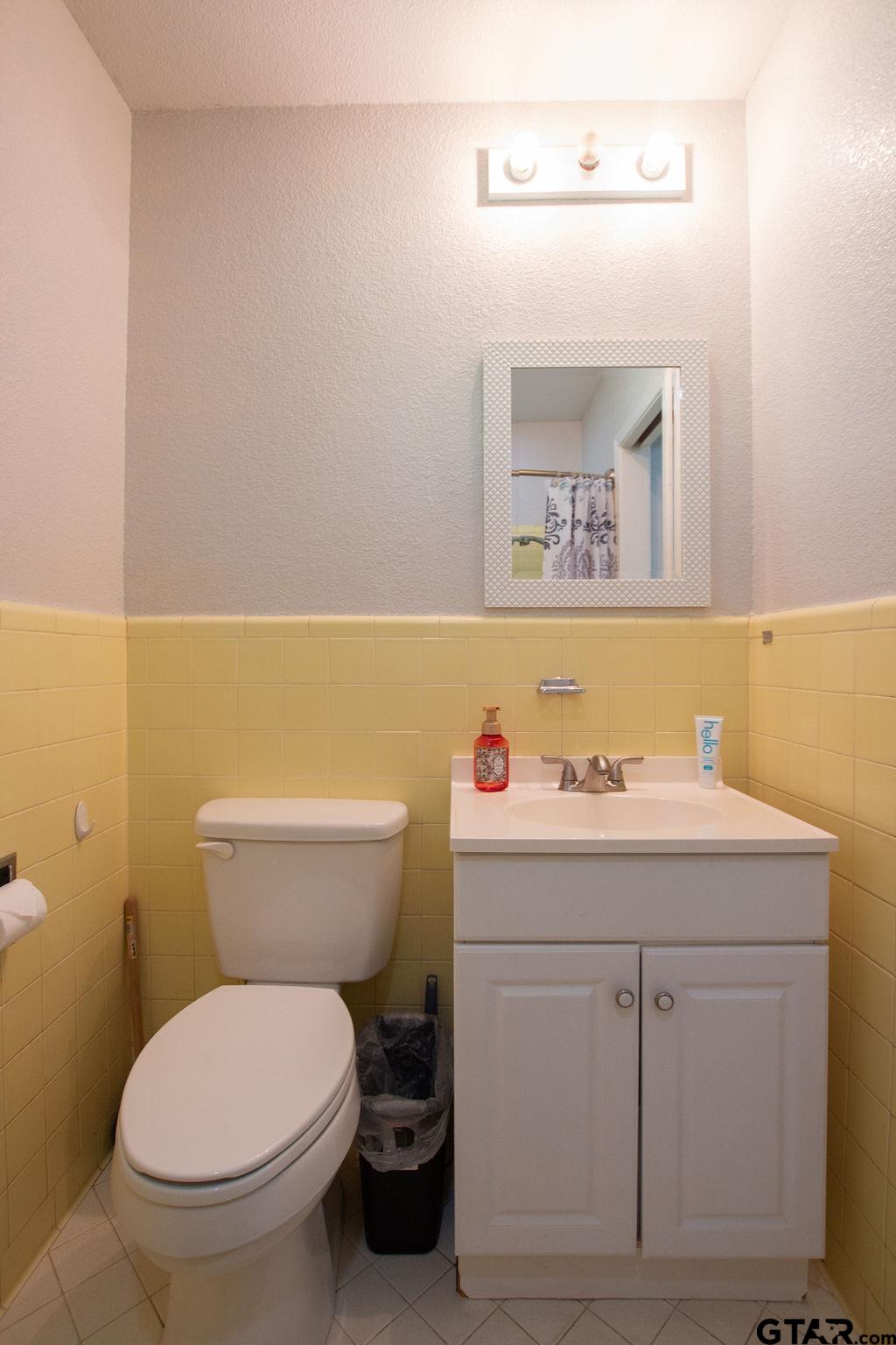 2110 Inwood Circle Tyler, TX 75701 - Photo 26 of 44 a bathroom with a toilet a sink and mirror