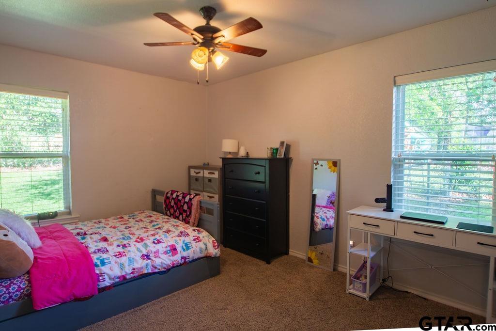 2110 Inwood Circle Tyler, TX 75701 - Photo 28 of 44 a bedroom with a bed and a window