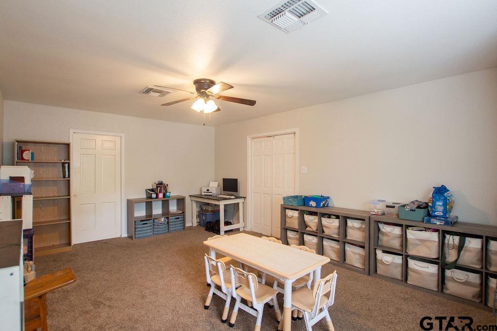 2110 Inwood Circle Tyler, TX 75701 - Photo 34 of 44 a bedroom with furniture and a chandelier