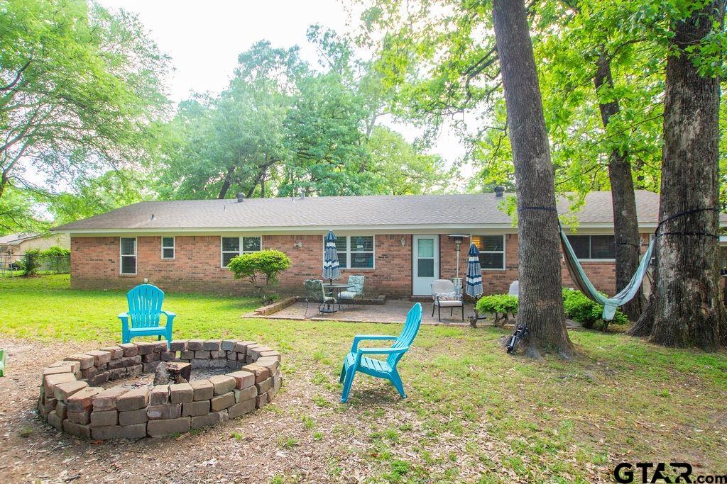 2110 Inwood Circle Tyler, TX 75701 - Photo 38 of 44 a front view of house with garden and patio