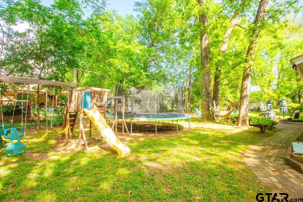 2110 Inwood Circle Tyler, TX 75701 - Photo 39 of 44 a view of a swimming pool with a patio