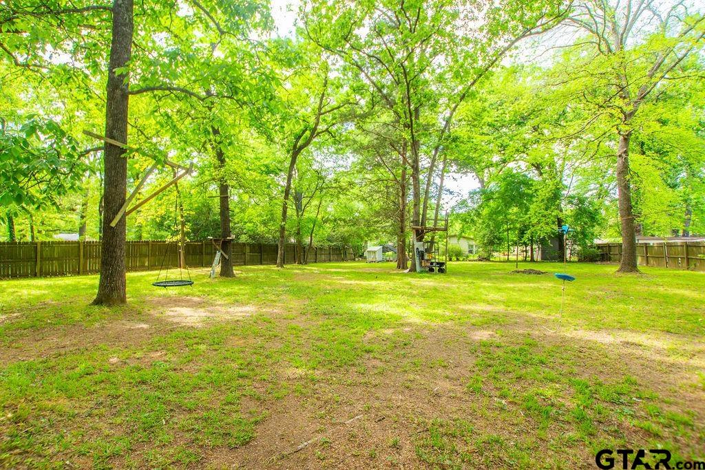 2110 Inwood Circle Tyler, TX 75701 - Photo 41 of 44 a view of swimming pool with trees and grass